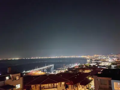 a view of a city with a harbor at night at Ela, Kedar 5 in Sveti Vlas