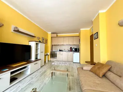 a living room with a couch and a tv at Royal Dreams apartments - 2 in Sunny Beach