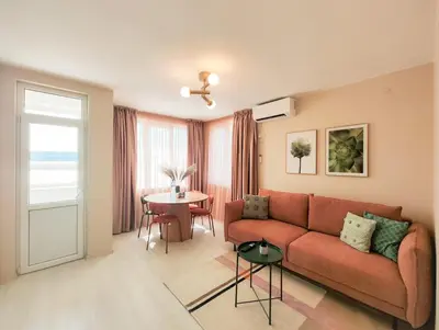 a living room with a couch and a table at Marina's Flat in Varna City