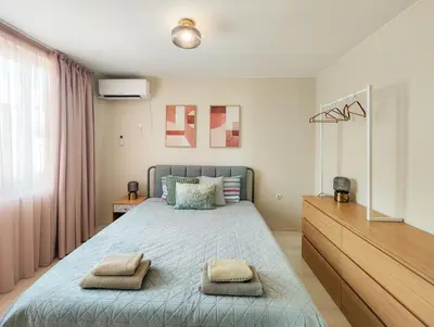 a bedroom with a bed with two towels on it at Marina's Flat in Varna City