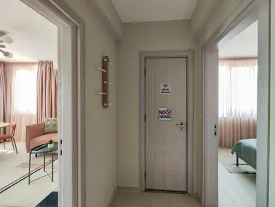 a hallway with a door with a sign on it at Marina's Flat in Varna City