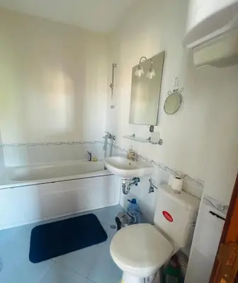 a bathroom with a toilet and a sink and a tub at Kasandra Apart Hotel in Sunny Beach