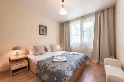 a small bedroom with a bed and a window at Aristocratic to the Sea Garden in Varna City
