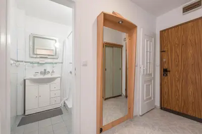 a bathroom with a sink and a mirror and a door at Aristocratic to the Sea Garden in Varna City