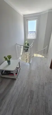a white room with a staircase and a table at New 3Room Maisonette Apartment in Sunny Day 3 Sunny Beach in Sunny Beach