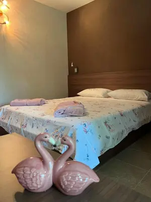two pink flamingos sitting on top of a bed at GREEN PARADISE apartments in Sveti Vlas