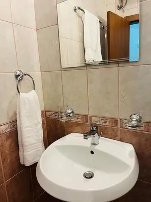 a bathroom with a white sink and a mirror at Green Paradise apartments in Sveti Vlas