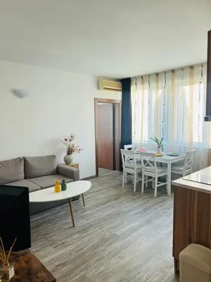 a living room with a couch and a table at Green Paradise apartments in Sveti Vlas