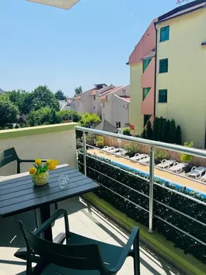 a table and chairs on a balcony with a view at Green Paradise apartments in Sveti Vlas