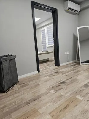 an empty room with a mirror and wooden floors at Central Flat, Close to the beach in Burgas City