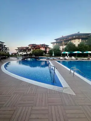 a large swimming pool in a city with buildings at Complex Gallery Saint Thomas in Sozopol