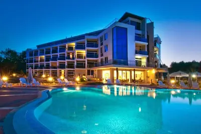 a hotel with a swimming pool in front of a building at Apartment Zornitsa I Panoramic Sea View in Sozopol
