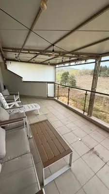 a large living room with a view of a field at Apartment Zornitsa I Panoramic Sea View in Sozopol