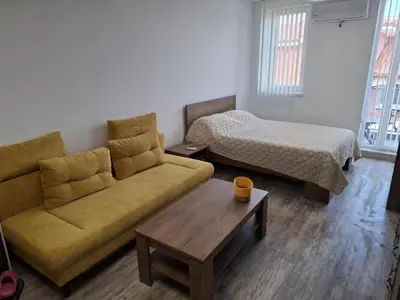 a living room with a couch and a bed at РАВДА Лазур Аурелия in Ravda