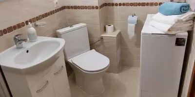 a bathroom with a white toilet and a sink at Ela, Kedar 3 in Sveti Vlas