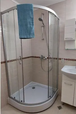 a shower with a blue towel in a bathroom at Ela, Kedar 3 in Sveti Vlas