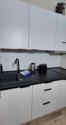 a kitchen with white cabinets and a sink at Ela, Kedar 3 in Sveti Vlas