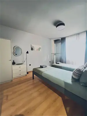 a bedroom with a large bed and a large window at Heart of City, Steps to Beach in Burgas City