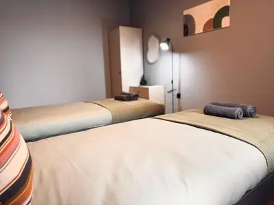 a room with two beds in a room at Heart of City, Steps to Beach in Burgas City