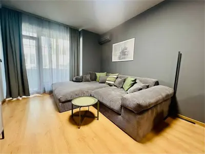 a living room with a couch and a table at Heart of City, Steps to Beach in Burgas City