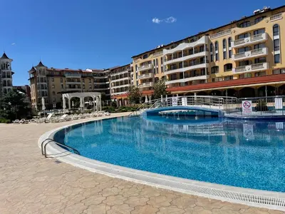 a large swimming pool in front of a building at Royal Sun SP apartments in Sunny Beach