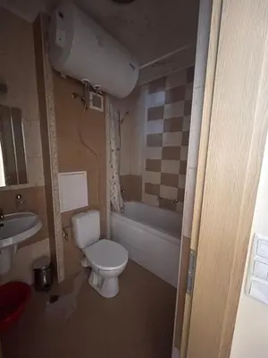 a bathroom with a toilet and a tub and a sink at Royal Sun SP apartments in Sunny Beach