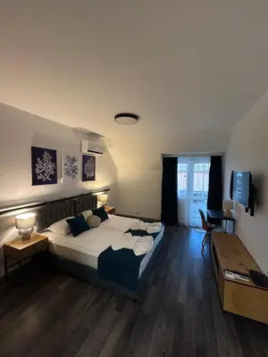 a bedroom with a large bed in a room at Апартаменти Лилия 2 in Primorsko