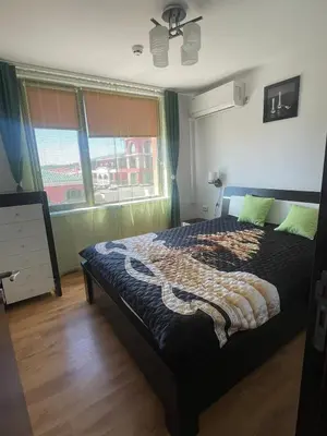 a bedroom with a bed and a window at Raduga SP apartments St Vlas in Sunny Beach