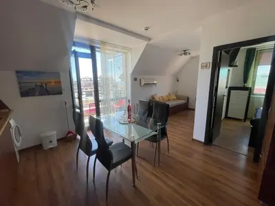 a dining room with a glass table and chairs at Raduga SP apartments St Vlas in Sunny Beach