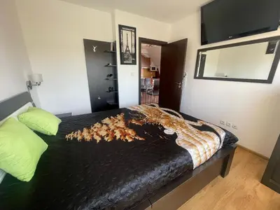 a bedroom with a bed with a pile of leaves on it at Raduga SP apartments St Vlas in Sunny Beach