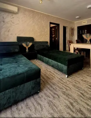 a living room with two green beds and a table at White Cliffs первая линия in Byala