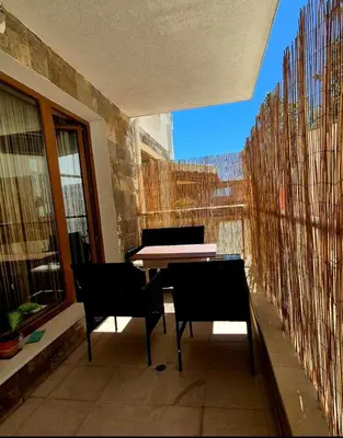 a balcony with a table and chairs in a building at White Cliffs первая линия in Byala