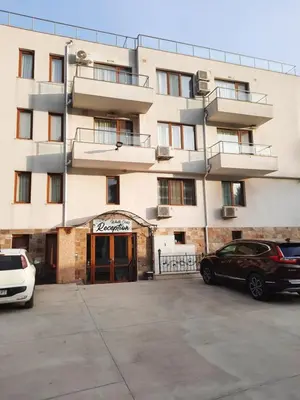 a building with cars parked in front of it at White Cliffs первая линия in Byala