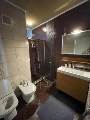 a bathroom with a toilet and a sink and a shower at First Line Lozenez Beach Anron in Lozenets
