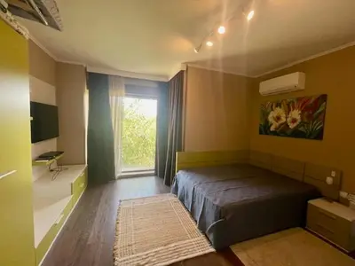a bedroom with a bed and a window at First Line Lozenez Beach Anron in Lozenets