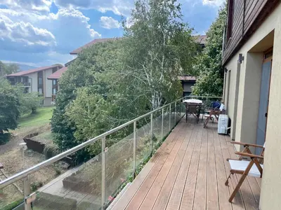 a wooden deck with a table and chairs on it at First Line Lozenez Beach Anron in Lozenets