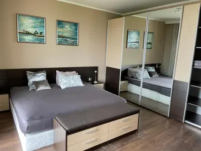 a bedroom with a large bed and a mirror at First Line Lozenez Beach Anron in Lozenets