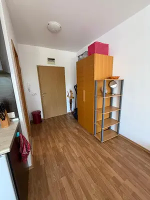 a living room with a wooden floor and a closet at Vineyards Resort, Aheloy - Studio 32 in Pomorie