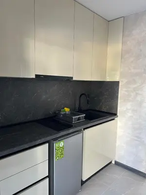 a kitchen with white cabinets and a sink at Sozopol Beach Apartments in Sozopol