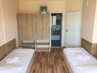 a room with two beds and a bathroom at ВС Морски дюни in Shkorpilovtsi