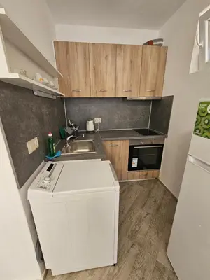 a small kitchen with a sink and a refrigerator at Студио Морелия in Tsarevo