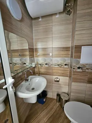 a bathroom with a sink and a toilet at Студио Морелия in Tsarevo