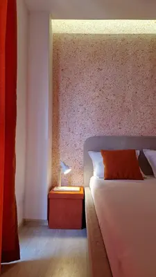 a bedroom with a bed and a table with a lamp at Геновева in Kiten