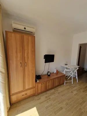a room with a large wooden cabinet and a table at Villa Astoria 2 - Premium Apartments in Elenite