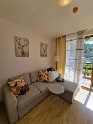 a living room with a couch and a table and a window at Villa Astoria 2 - Premium Apartments in Elenite