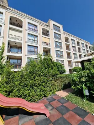 a large building with a red bench in front of it at Villa Astoria 2 - Premium Apartments in Elenite