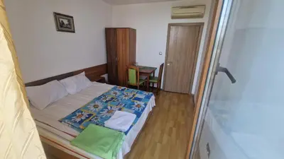 a small bedroom with a bed and a table at One bedroom studio in Chernomorets