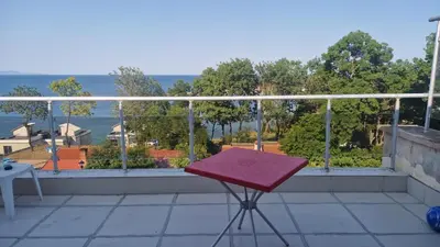 a red chair sitting on top of a balcony at One bedroom studio in Chernomorets