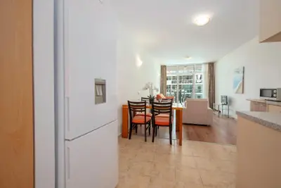 a kitchen and dining room with a table and chairs at Sunny Holiday Apartments in Sunny Beach