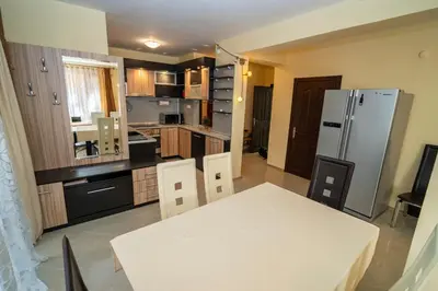 a kitchen with a white table and a refrigerator at The Family Courtyard - Very LARGE 2BD Apartment by Flat Manаger in Ravda